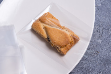 biscuit in cellophane bag on porcelain plate