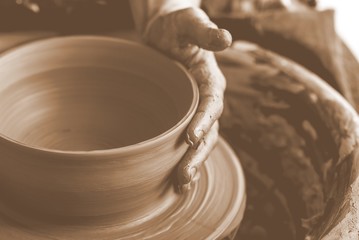 Hand of potter doing clay pot