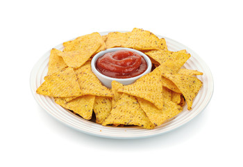 Dish of nacho chips and tomato dip sauce