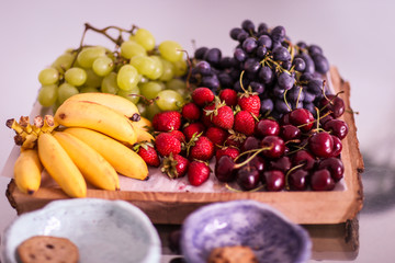 Naklejka na ściany i meble Fruits on a wooden plate