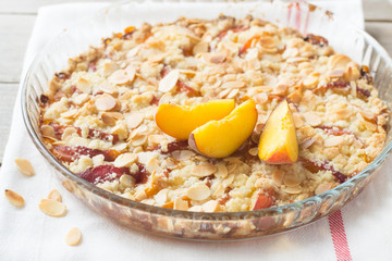 Peach crumble on a wooden and textile background
