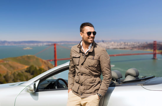 Road Trip, Travel And People Concept - Happy Man Near Convertible Car Over Golden Gate Bridge In San Francisco Bay Background