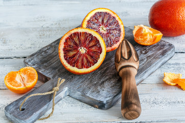 Halves of blood orange and citrus press.