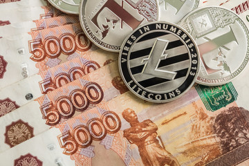Fototapeta na wymiar Silver crypto coins Litecoin LTC, Russian rubles. Metal coins are laid out in a smooth background to each other, close-up view from the top, crypto currency exchange of money.