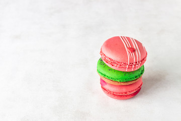 Colorful french macarons on light grey background