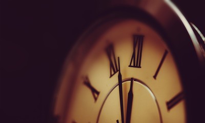Vintage metal clock on wite background