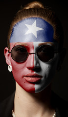 Portrait of woman with painted Texas USA state flag with sunglasses