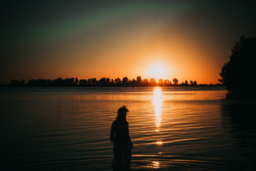 Silhouette girl against the backdrop of Sunrise