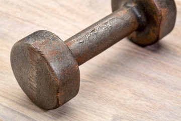 vintage iron dumbbell on wood