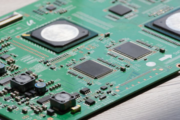 Close up photo of circuit board on wooden background