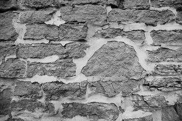 Black and white texture of an old stone wall