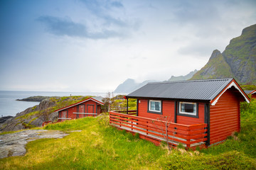Fototapeta na wymiar Traditional red camping houses with a beautiful sea view next to village A, lofoten, Norway