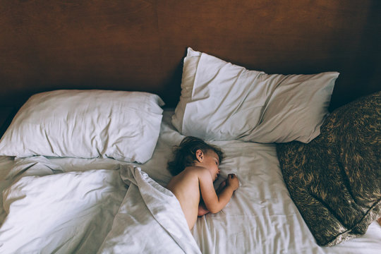 Portrait of adorable baby girl sleeping in bed