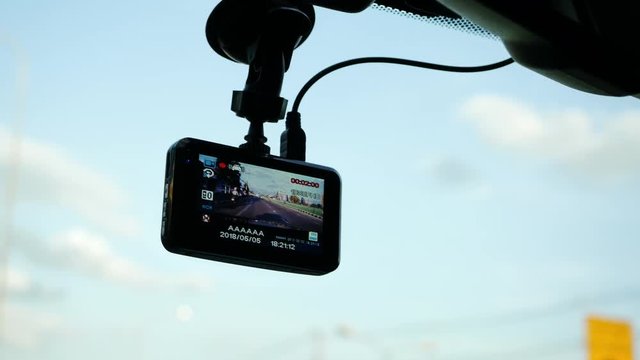 video camera recorder in car driving on traffic road