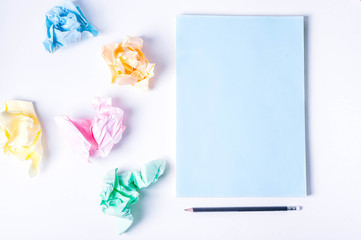 Crumpled colored paper on a white background, smooth blue sheet