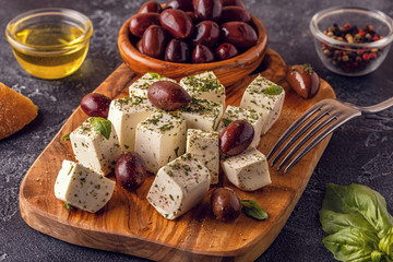 Greek cheese feta with oregano and olives.