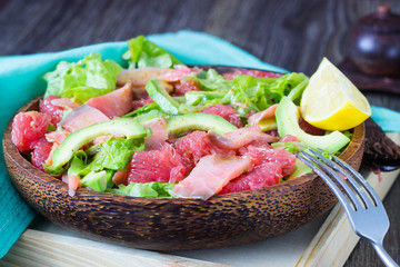 Healthy salad with salmon, grapefruit, avocado and mustard sauce. Delicious balanced food concept
