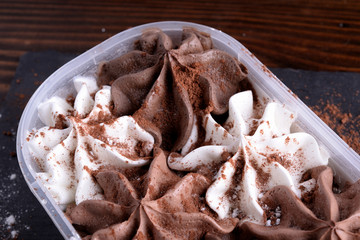 Milk chocolate ice cream, white and dark in a bowl 