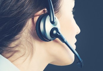 Woman call center operator on dark background