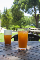 Two glasses with orange juice and ice