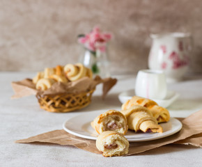 Fototapeta premium Red berry filling short crust pastry crescent rolls cookies. Jam rugelach (croissant), freshly baked sweet buns or bread rolls. Copy space for your text