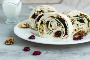 Avocado and chicken salad roll sandwich. Roll sandwich with chicken, avocado, dried cranberries and walnuts. Thin Armenian pita bread or lavash. Snack.