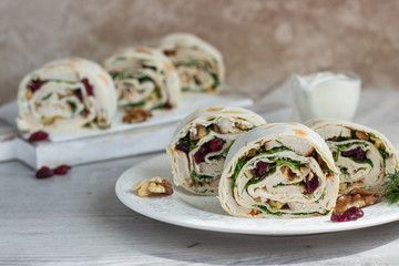 Avocado and chicken salad roll sandwich. Roll sandwich with chicken, avocado, dried cranberries and walnuts. Thin Armenian pita bread or lavash. Snack.