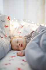 Fototapeta na wymiar Portrait of adorable baby girl sleeping in bed