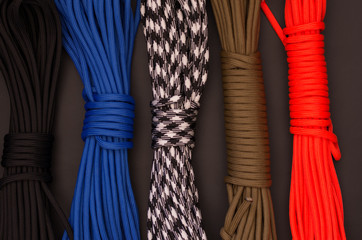 Multicolored ropes. Multicolored paracord. Various convolutions of threads.