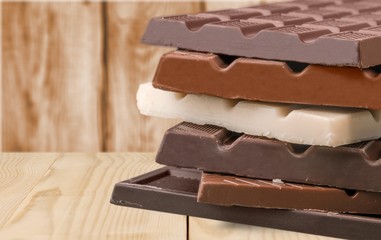 Delicious chocolates on wooden background
