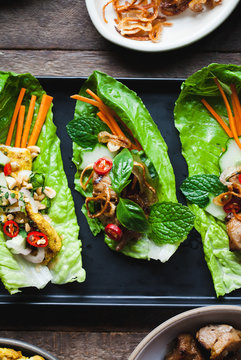 Thai lettuce cups on wood background