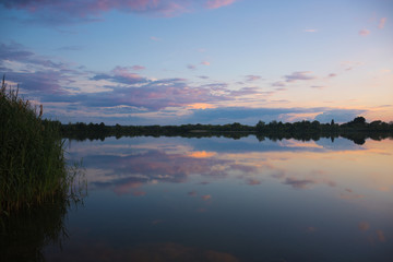Landscape - calm fishing lake with sunset rteflection