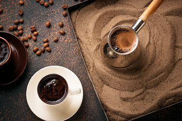 Traditional turkish coffee prepared on hot sand - obrazy, fototapety, plakaty
