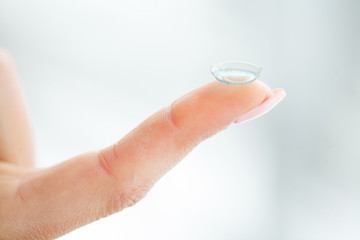 Vision Contact Lenses. Woman holds finger on a contact lens, closeup
