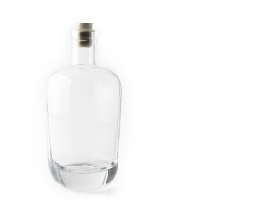 Empty glass bottle with the cork on the white