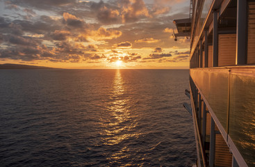 Cruise ship at sea with sun setting