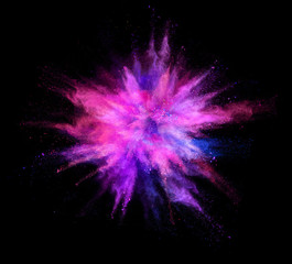 Explosion of coloured powder on black background