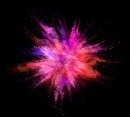 Explosion of coloured powder on black background