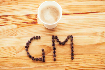Good Morning. Coffee Time. Coffee to go and beans on a wooden background