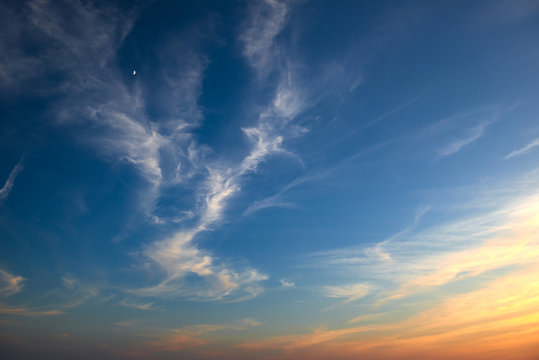 beautiful sunset with moon and sky as background, colorful clouds