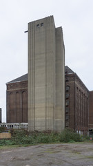 Fototapeta na wymiar Old industrial building made of bricks in cloudy weather