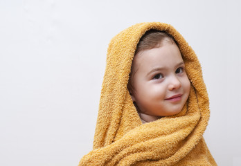 Obraz premium Cute happy smiling Baby Girl in soft Hooded Towel after Bath