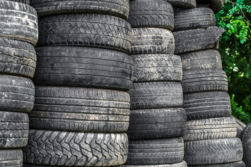 Old used car tires stacked in stacks