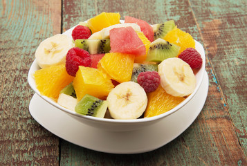 fresh healthy fruit salad on wooden background