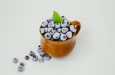 frozen blueberries in a clay cup