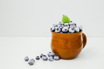 frozen blueberries in a clay cup