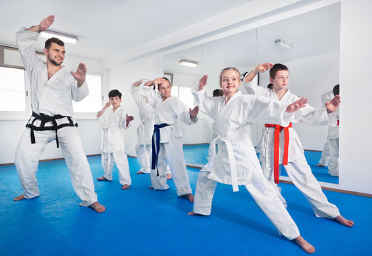 Children trying martial moves in karate class