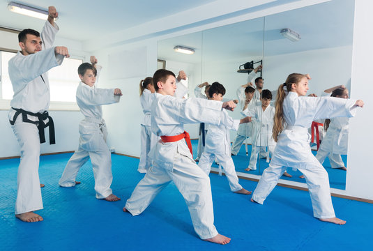 Children trying a new moves during karate class