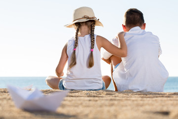 two kids sitting back