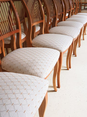Chairs with soft seats are in a row.